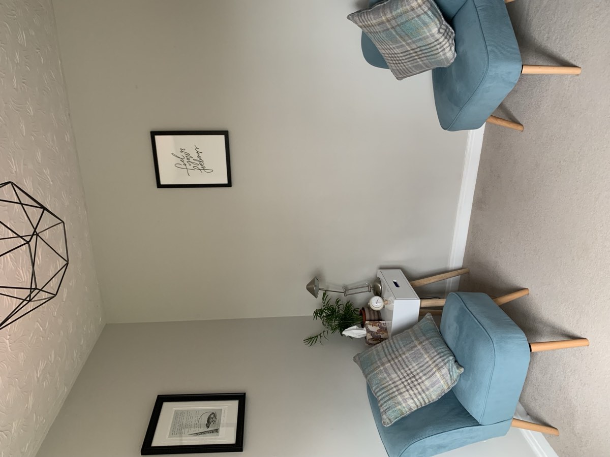 The counselling room — two soft armchairs by a window